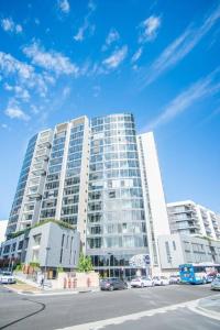 a large building with cars parked in front of it at Minimalism modern apartment*waterview*parking＊IGA in Sydney