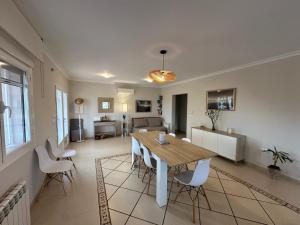 a dining room and living room with a table and chairs at Villa Maja in Calpe