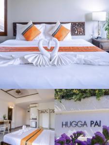 two beds in a hotel room with two hearts at Hugga Pai in Pai