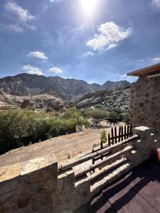 a stone bench overlooking a view of the mountains at Hiking break 