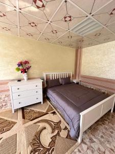 a bedroom with a large bed and a white dresser at Hiking break 