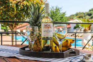 een fles wijn en glazen op een tafel bij Villa Anni in Skiathos-stad