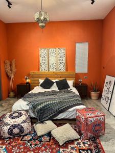 a bedroom with orange walls and a large bed at Third Sister B&B in Xiaoliuqiu