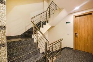 a staircase in a building with a wooden door at FabHotel Royal Residency I in New Delhi