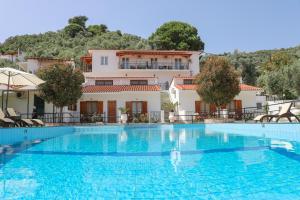 a large swimming pool in front of a house at Villa Anni in Skiathos