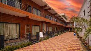 a hallway of a building with a sunset in the background at Sea Queen Beach Resort On Beach in Mandarmoni