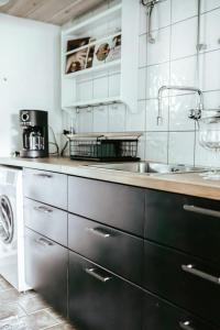 a kitchen with a sink and a counter at Östra Nyrups Lantliv in Höör