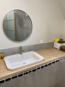 a bathroom with a sink and a mirror on a counter at La marée in Étaples +9 photos