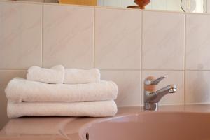 a pile of towels sitting on top of a sink at Casa Rosa in Arisdorf