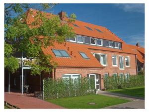 a large brick house with an orange roof at Haus Delft Phyllis in Juist