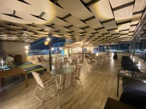 a restaurant with tables and chairs in a room at Alena Boutique Hotel in Aqaba