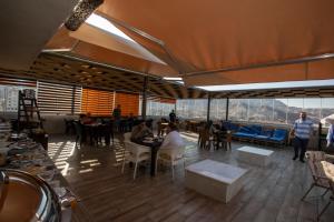 a restaurant with tables and people sitting at tables at Alena Boutique Hotel in Aqaba