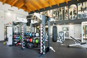 a gym with a punching bag and weights at Kierland Commons CozySuites next to golf course in Scottsdale