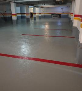 an empty parking garage with a red line on the floor at Hôtel privilège Oran in Oran
