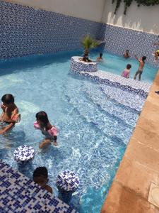 un grupo de niños jugando en una piscina en Hôtel privilège Oran, en Orán