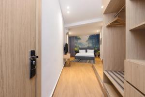 A bed or beds in a room at Tree House Boutique Hotel