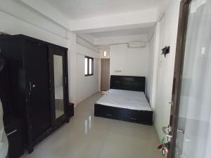 Habitación pequeña con cama y espejo. en Kost Salsabila Cisauk en Kedemangan-wetan