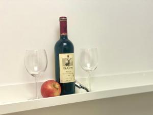 a bottle of wine and an apple on a shelf at Suit Dreams Vilaflor by Deihu Experiences in Vilaflor +10 photos