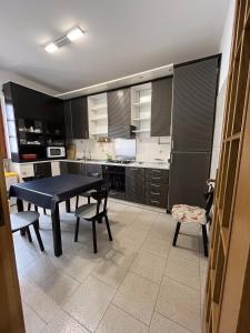 eine Küche mit einem Tisch und Stühlen im Zimmer in der Unterkunft Appartamento A due passi dal mare in Caulonia Marina