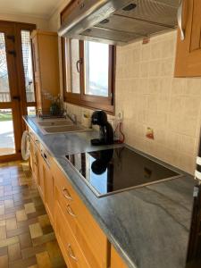 a kitchen with a counter top with a sink at Appartement T3 avec vue sur le lac in Chorges