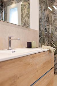 un baño con lavabo y espejo en Green Apartments a Igea Marina - jungle, en Bellaria-Igea Marina