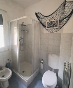 a bathroom with a shower and a toilet and a sink at Dal Pontevecchio House in Casarza Ligure