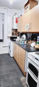 a kitchen with a stove and a microwave at 465 Bolton Road Next to Blackburn Stadium in Cherry Tree