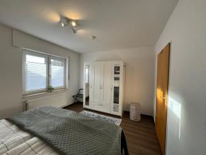 a bedroom with a bed and a window at Ferienhaus Tamko 95161 in Rhauderfehn