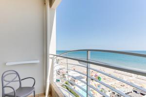 a balcony with a view of the beach and the ocean at MARITTIMO Riccione - H Clipper in Riccione