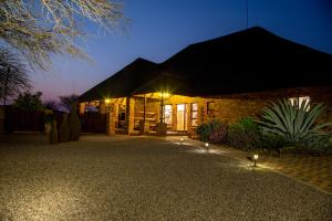 a building with lights in front of it at night at Sondela Nature Reserve & Spa Makhato Lodges in Bela-Bela