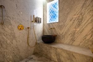 a bathroom with a shower with a bowl on the ledge at Kate Hotel Special Class & SPA in Istanbul