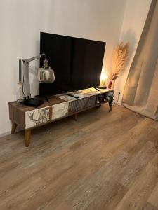a flat screen tv sitting on a table in a living room at Coquet appartement in Canet-en-Roussillon