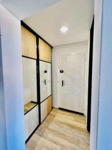 a room with a hallway with a closet and a door at Coquet appartement in Canet-en-Roussillon +18 photos