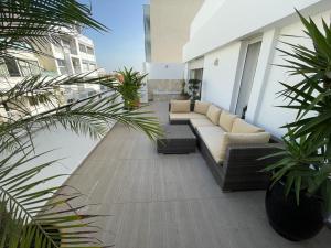 un patio con sofá y algunas plantas en un edificio en Central, terrasse, confortable - Bleue résidence en Casablanca