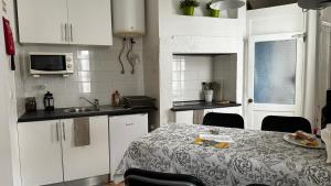 a kitchen with white cabinets and a table with a plate on it at Casa do Conde in Lisbon