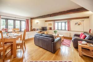 a living room with a couch and a table at South Barn, Nr Southwold in Southwold