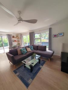 a living room with a couch and a coffee table at Townhouses by the Beach in Thirroul