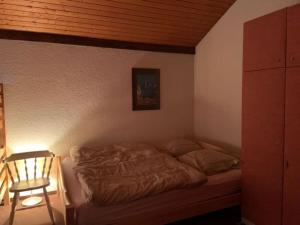 a bed in a bedroom with a wooden ceiling at Résidence A9 - Les Myosotis in Les Mosses