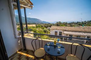 uma varanda com uma mesa e cadeiras e uma vista em Aggeliki apartments Dassia By Hotelius em Kato Korakiana