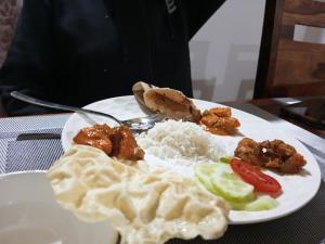 a plate of food with rice and vegetables on a table at Hotel Onpo Hunder Nubra Valley in Hundar