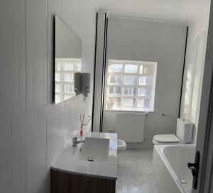 a white bathroom with a sink and a toilet at Viviendas vacacionales as lagas in Palas de Rei