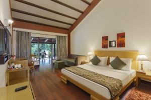 a bedroom with a bed and a living room at The Riverview Retreat Corbett by Leisure Hotels in Garjia