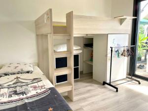 a small bedroom with a bunk bed and a room with a window at Kaz Ajeya in Les Avirons +34 photos