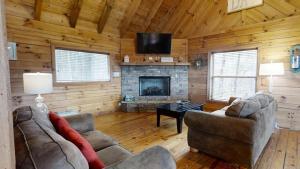 ein Wohnzimmer mit 2 Sofas und einem Kamin in der Unterkunft Evie's Mountain Castle cabin in Townsend