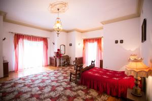 a bedroom with a red bed in a room at U Schabińskiej - Pałac w Gorlicach in Gorlice