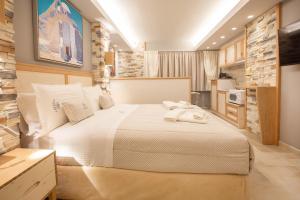 a bedroom with a large white bed in a room at Mariet Athens Boutique Spa in Athens