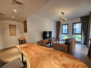 a living room with a large wooden bed in it at PALACE DOWNTOWN APARTMENT in Dubai