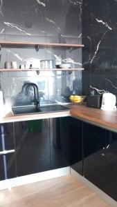 a kitchen with a sink and a counter top at Carob apartment - Balcony view of the sea & Bisevo in Komiža