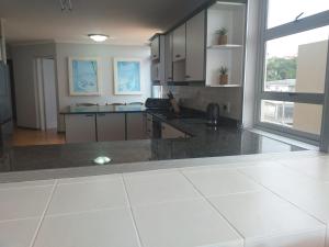 a large kitchen with a large window and a counter top at Rondevoux 27 in Margate