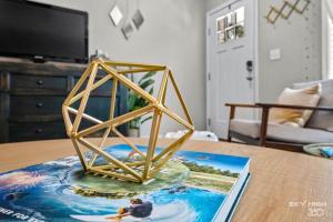 a gold geometric sculpture on a table in a living room at NEW! Boho Bungalow in Bella Vista